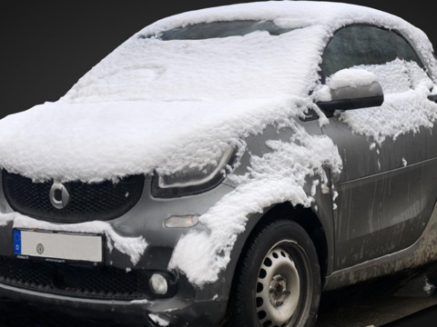 Smart cars covered in snow